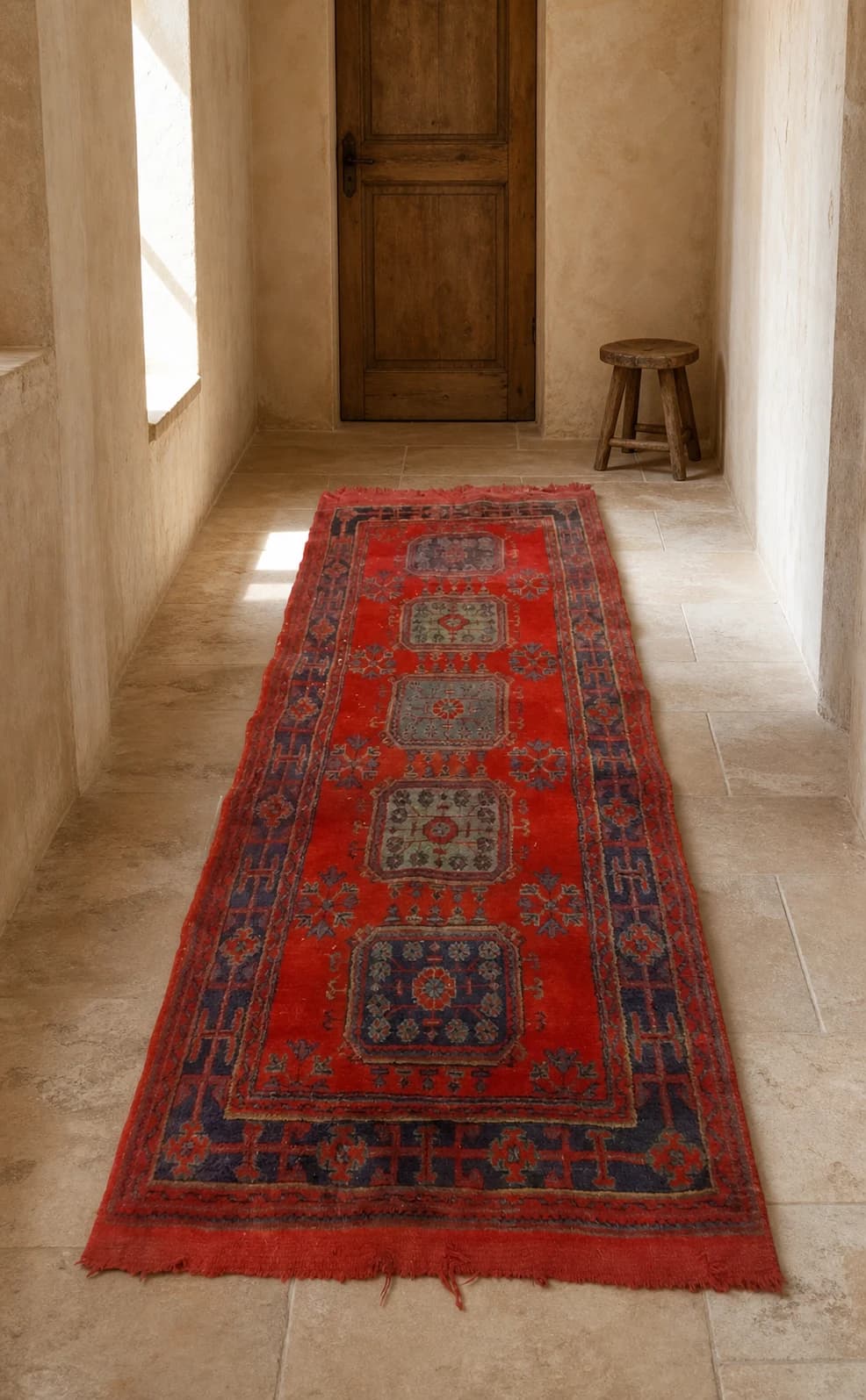 Long red vintage Anatolian runner with a central medallion and geometric border.