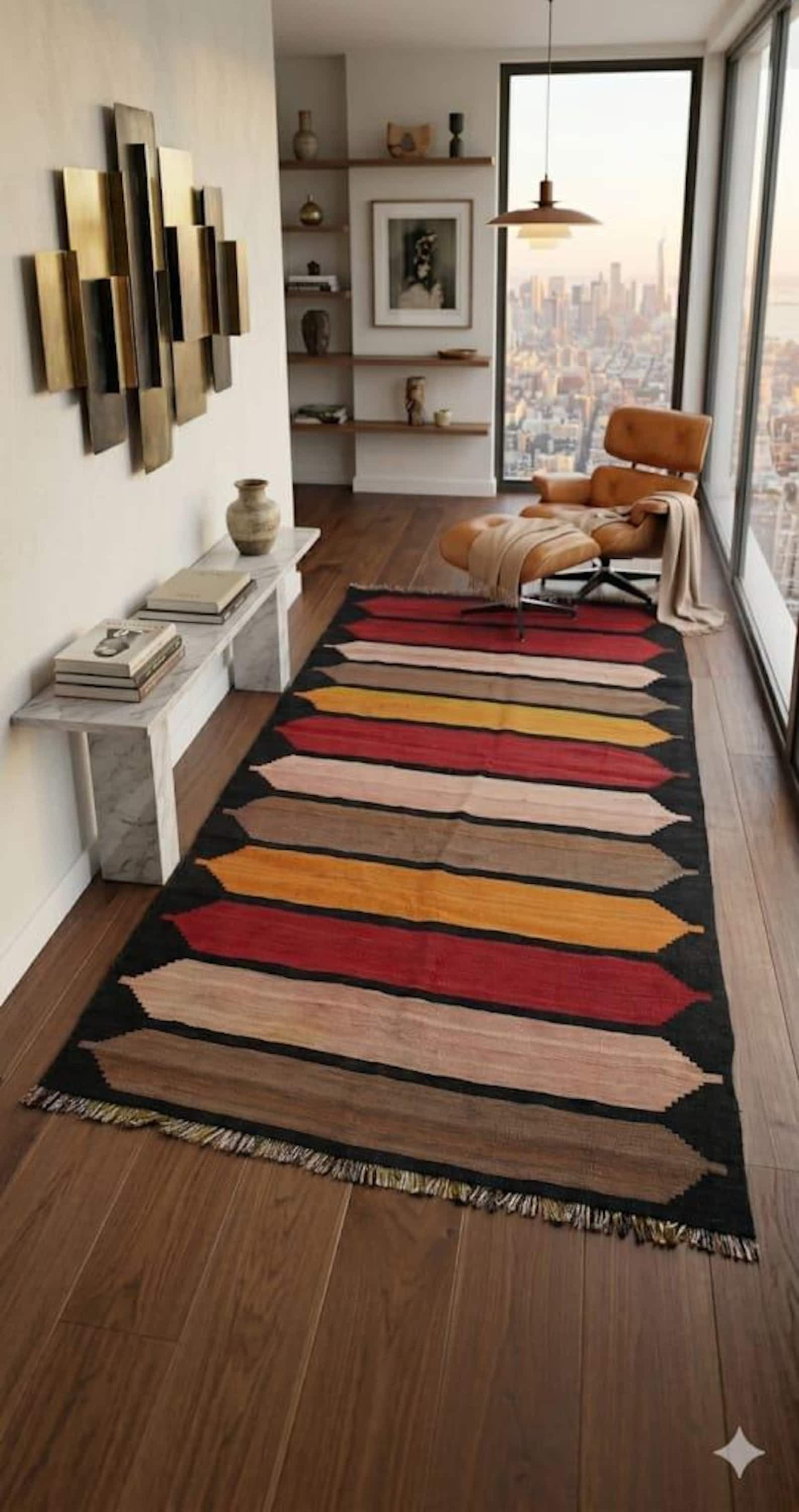 A black striped Anatolian kilim running toward a floor-to-ceiling city view.